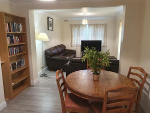 a living room with a table and a couch at Elegant house 10 minutes walk to wembley stadium in London