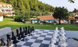 a chess board with a game of chess at Palladium Hotel in Kriopigi