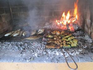 a grill with many different types of food on it at Apartments A&G in Kaštela