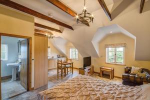 a large bedroom with a bed and a kitchen at Woodleighton Cottages in Uttoxeter