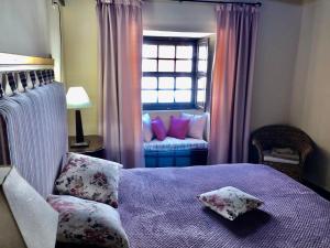 a bedroom with a bed with pillows and a window at Hotel Rural Vilaflor Self Check In 24h in Vilaflor +81 photos