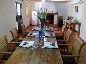 a long wooden table in a room with chairs at B&B Cortijo El Ciruelo in Chirivel