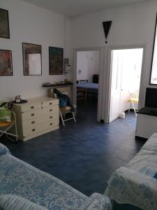 a room with two beds and a dresser and a bedroom at Celle mare con posto auto coperto in Celle Ligure
