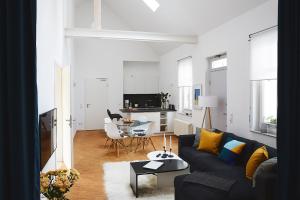 a living room with a couch and a table at Altstadtloft Teltow in Teltow