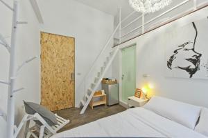 a bedroom with a white bed and a staircase at Leo 111/Arena Ruifeng in Kaohsiung