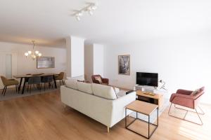 a living room with a couch and a dining room at TravelingToLisbon 342 - Avenida 5 de Outubro in Lisbon