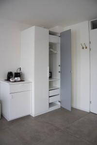 um quarto com paredes brancas e um armário branco em B&B Mondriaan em Amsterdã