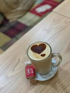 a cup of coffee with a heart on top of it at Abbey Guest House in Peterhead