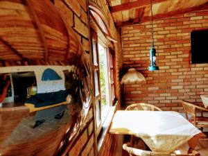 a room with a table and a brick wall at SPACE 4 U - HOTEL BOUTIQUE TEMÁTICO - Aeroporto in São José dos Pinhais +19 photos