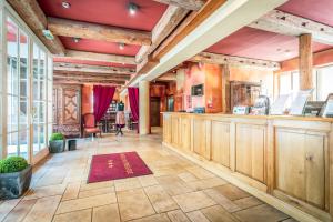 a large room with a bar with wooden cabinets at Hôtel Du Théâtre Centre Historique - Parking Souterrain Public Gratuit in Metz