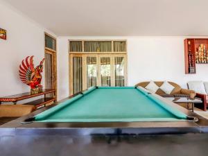 a pool table in the middle of a living room at Chendana Homestay Bali in Sanur