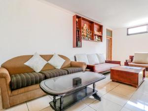 a living room with a couch and a coffee table at Chendana Homestay Bali in Sanur