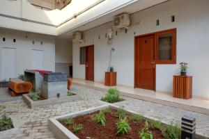 a room with a courtyard with a door and some plants at RedDoorz near Alun Alun Kudus 2 in Kudus