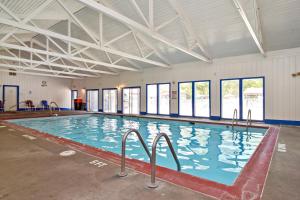 a large indoor swimming pool with blue water at Williamsburg Camping Resort One Bedroom Cabin 3 in Croaker