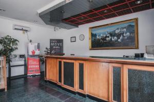 a bar in a room with a painting on the wall at RedDoorz Plus near Pelabuhan Merak in Cilegon