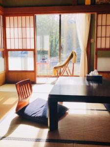 a room with a table and a chair and a window at STAY FUJI a in Yamanakako