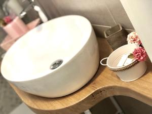 a white sink sitting on top of a wooden table at 30 METRI QUADRATI in Monopoli +18 photos