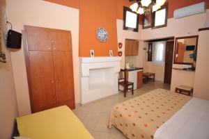 a small bedroom with a bed and a kitchen at Sofia Pension in Rhodes Town