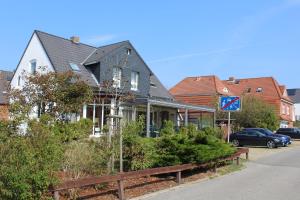 uma casa ao lado de uma rua em Hotel Südstrand Amrum em Wittdün
