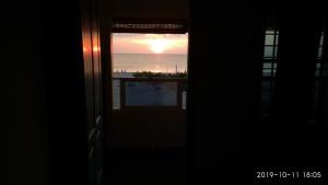 a window with a view of the ocean from a house at Alleppey Holiday Beach Resort in Alleppey