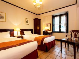 Postel nebo postele na pokoji v ubytování Hotel Monterey Osaka