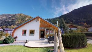 a small white house with a table and chairs at Villa Tschallener in Ried im Oberinntal