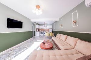 a living room with a couch and a table at Sofia Rococo Life Apartments in Sofia