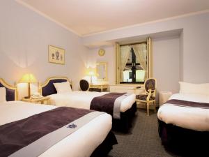 Postel nebo postele na pokoji v ubytování Hotel Monterey Osaka