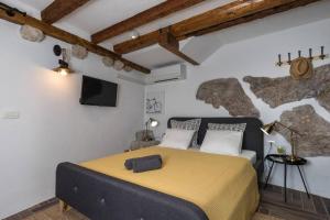 1 dormitorio con 1 cama y TV en una habitación en Private Accommodion Linda Studio, en Dubrovnik