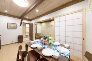 a dining room with a table and chairs at Shirakabanoyado - Nakamichi in Osaka