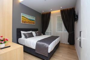a bedroom with a large bed in a room at Emerald Boutique Hotel in Tirana