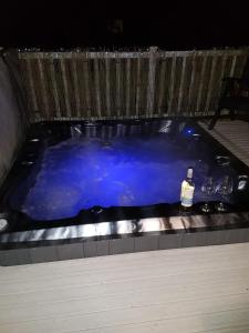 a hot tub with two glasses and a bottle of wine at Caravan for rent at Tattershall Holiday Park in Tattershall