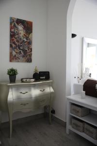 a white room with a dresser and a painting on the wall at Appartamento panoramico vicino a fiere e stadio in Milan