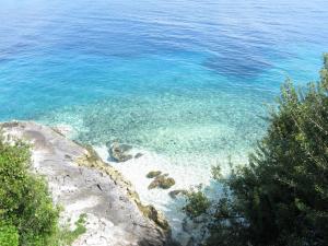 a view of the blue water of a beach at Stella Hotel Apartments in Fiskardo