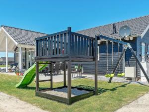 a playground with a slide and a swing set at 10 person holiday home in Hasselberg in Kappeln