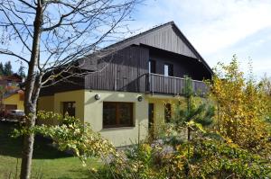 a house with a black and yellow facade at Holiday Villa Lipno Lake in Lipno nad Vltavou