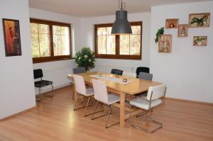 a dining room with a wooden table and chairs at Holiday Villa Lipno Lake in Lipno nad Vltavou