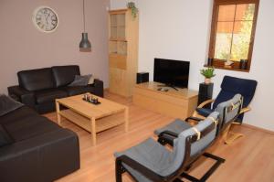 a living room with a couch and a table at Holiday Villa Lipno Lake in Lipno nad Vltavou