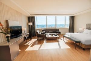 a hotel room with a bed and a living room at Mogador Marina in Casablanca