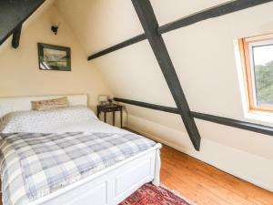 a bedroom with a bed and a window at Gerlan in Llandysul