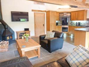 ein Wohnzimmer mit Sofa und Tisch in der Unterkunft Yew Tree Cottage in Coniston