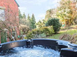 a bath tub filled with water in a yard at The Old Vicarage in Hereford