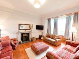 a living room filled with furniture and a fireplace at The Old Vicarage in Hereford