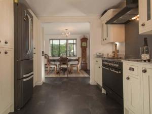 a kitchen with a table and a dining room at Kilcarreg in Wadebridge