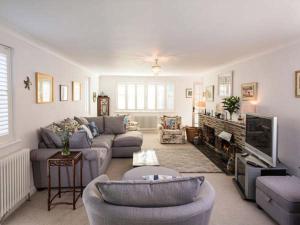 a living room with a couch and a tv at Kilcarreg in Wadebridge