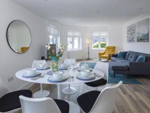 een woonkamer met een witte tafel en stoelen bij 3 Church Hill House in Salcombe