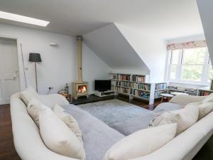 a living room with a couch and a fire place at The Pheasantry in Builth Wells