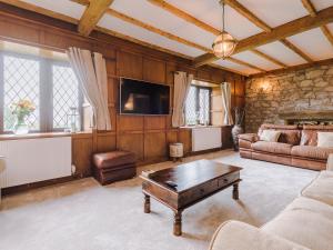 a living room with a couch and a coffee table at Arosfa in Holywell