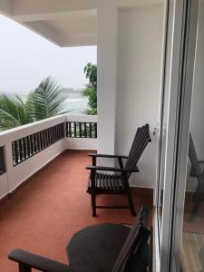 a balcony with a chair and a table at La Veranda Di Serena in Unawatuna