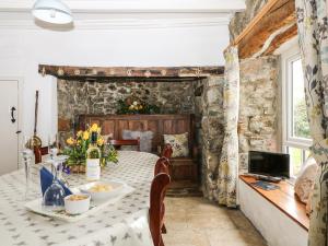 a dining room with a table and chairs at Penrose Farm Cottage in Saint Keverne